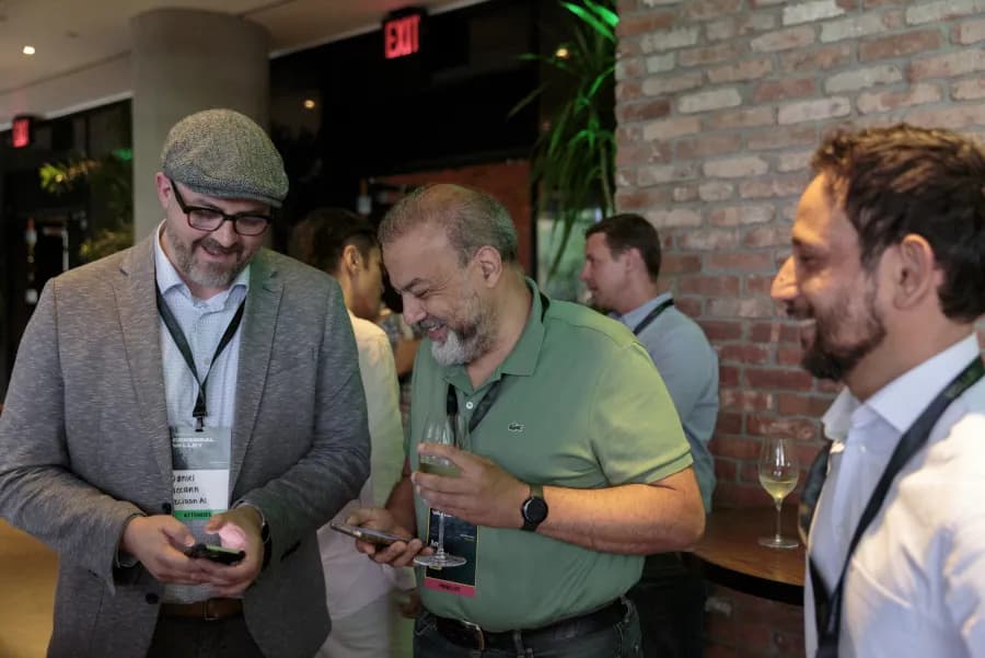 Attendees swapping contacts over drinks at the CVNY reception